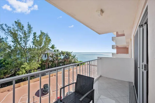 a balcony with wooden floor and fence