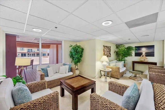 a living room with furniture a rug and a window