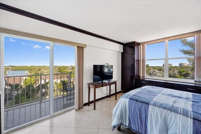 a bedroom with a bed and large window