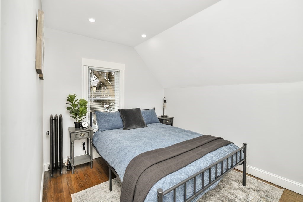 234 Rockland Street Canton, MA 02021 - Photo 21 of 38 a bedroom with a bed and a potted plant