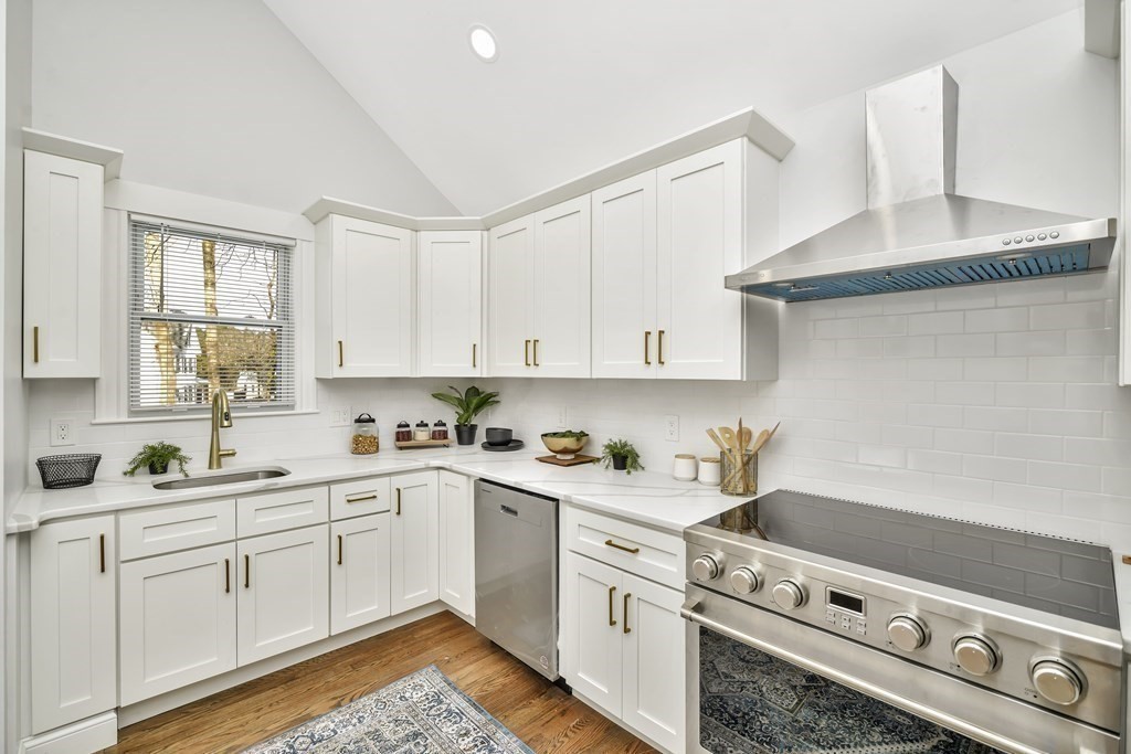 234 Rockland Street Canton, MA 02021 - Photo 4 of 38 a kitchen with a sink dishwasher stove and white cabinets