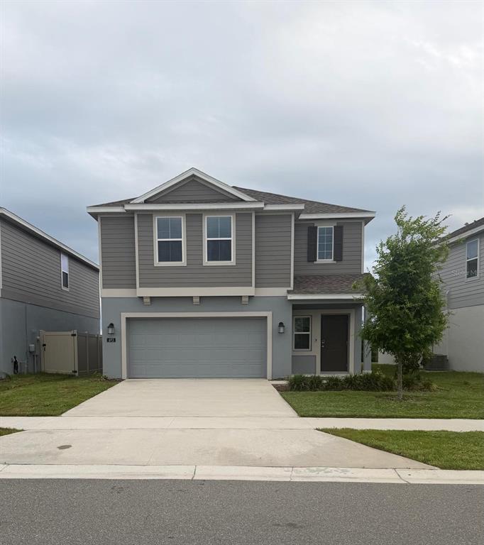 693 Reggie Road Winter Haven, FL 33859 - Photo 1 of 17 a front view of a house with a yard and garage