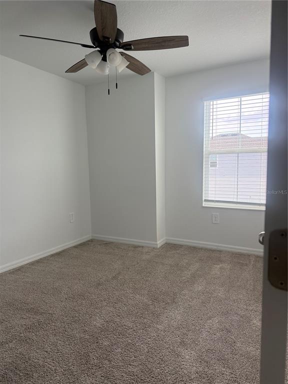 693 Reggie Road Winter Haven, FL 33859 - Photo 15 of 17 an empty room with a window and a fan