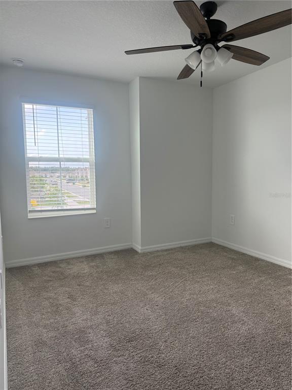693 Reggie Road Winter Haven, FL 33859 - Photo 16 of 17 an empty room with a window and a fan