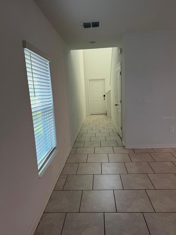 693 Reggie Road Winter Haven, FL 33859 - Photo 3 of 17 a view of an empty room with a window