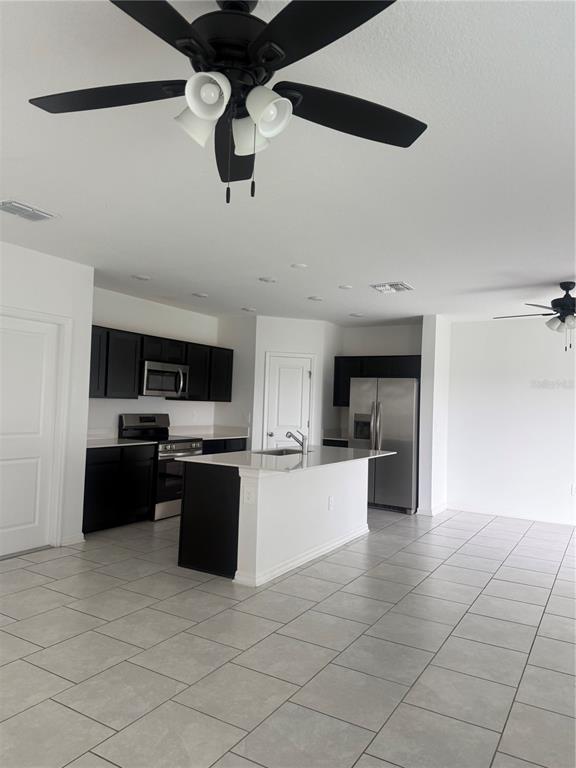 693 Reggie Road Winter Haven, FL 33859 - Photo 9 of 17 a kitchen with a sink cabinets and stainless steel appliances