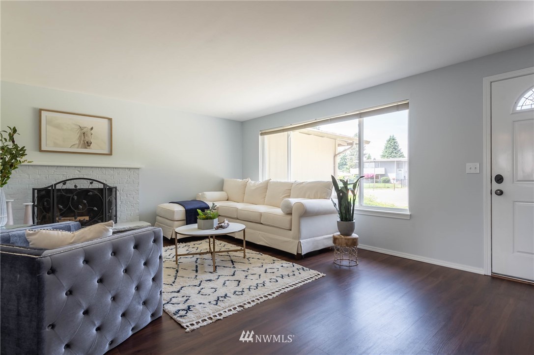 4131 Northeast 19th Street Renton, WA 98059 - Photo 2 of 40 a living room with furniture and a fireplace