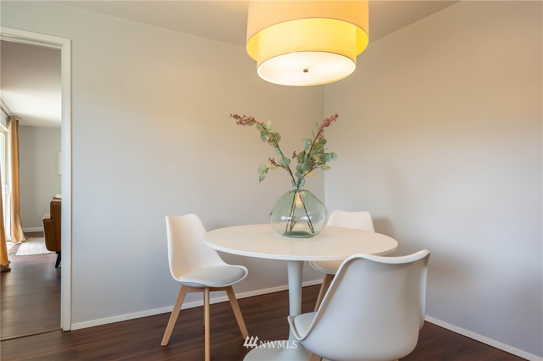4131 Northeast 19th Street Renton, WA 98059 - Photo 11 of 40 a view of a dining room with furniture and wooden floor
