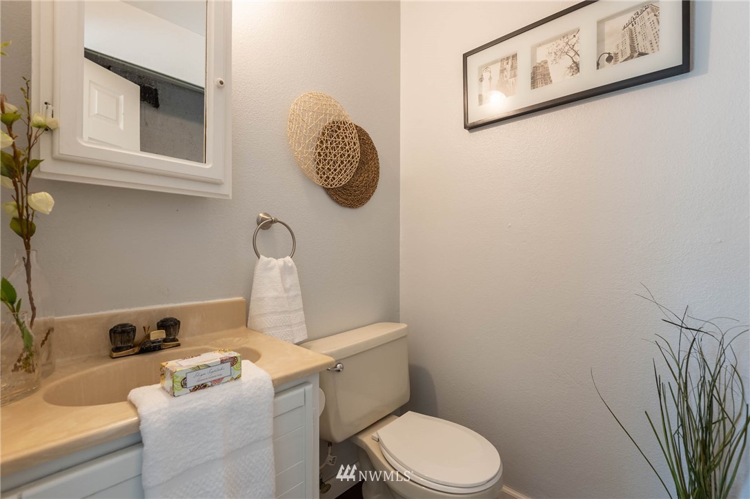 4131 Northeast 19th Street Renton, WA 98059 - Photo 18 of 40 a white toilet sitting next to a bathroom sink