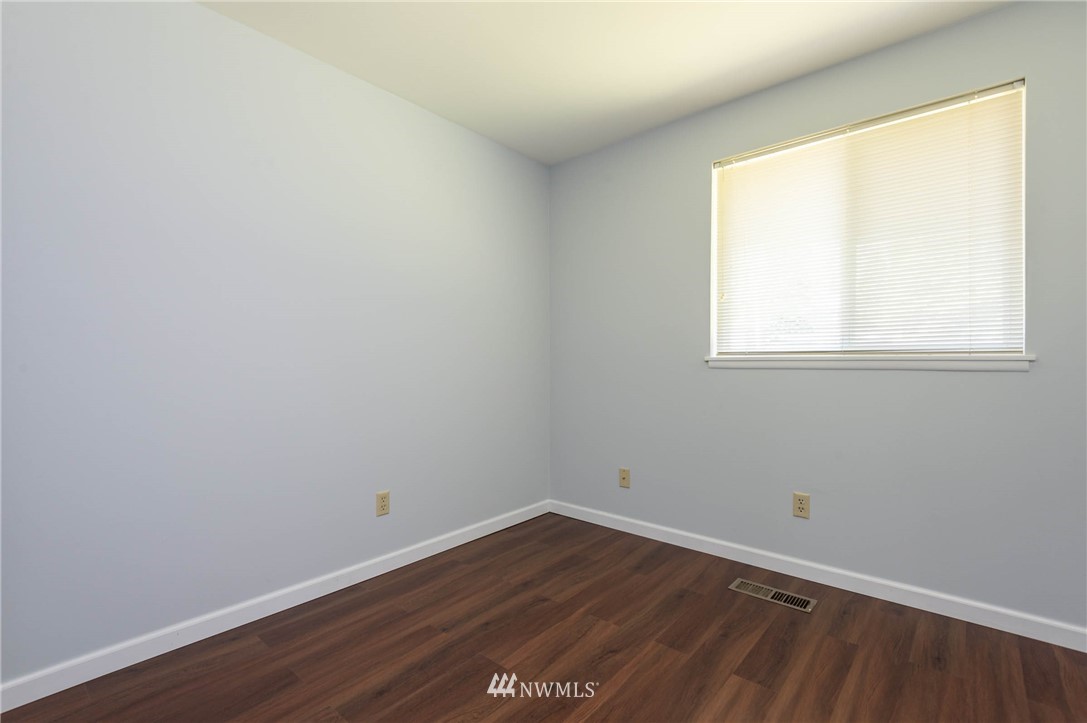 4131 Northeast 19th Street Renton, WA 98059 - Photo 23 of 40 an empty room with wooden floor and windows