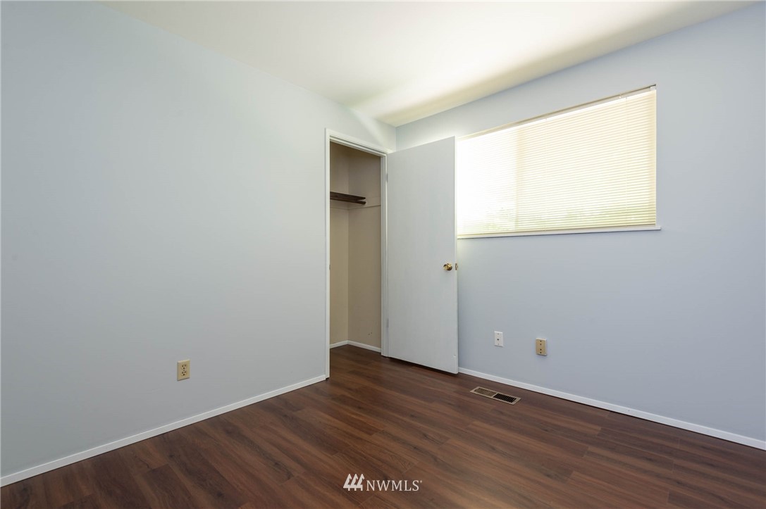4131 Northeast 19th Street Renton, WA 98059 - Photo 24 of 40 a view of an empty room with wooden floor and a window
