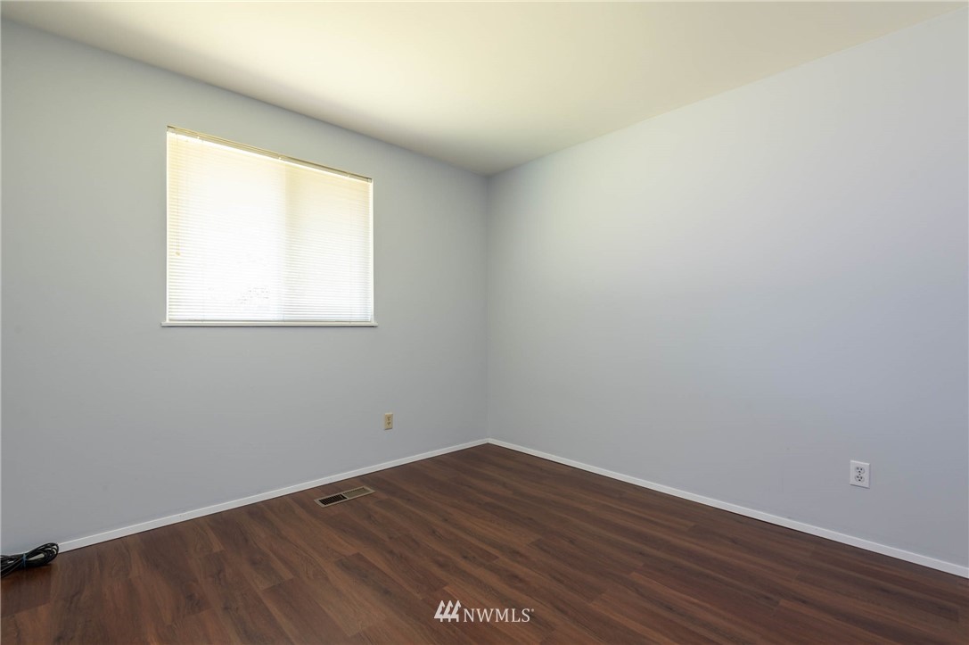 4131 Northeast 19th Street Renton, WA 98059 - Photo 27 of 40 an empty room with wooden floor and a window