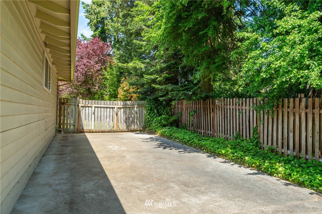 4131 Northeast 19th Street Renton, WA 98059 - Photo 33 of 40 a view of a pathway gate with wooden fence