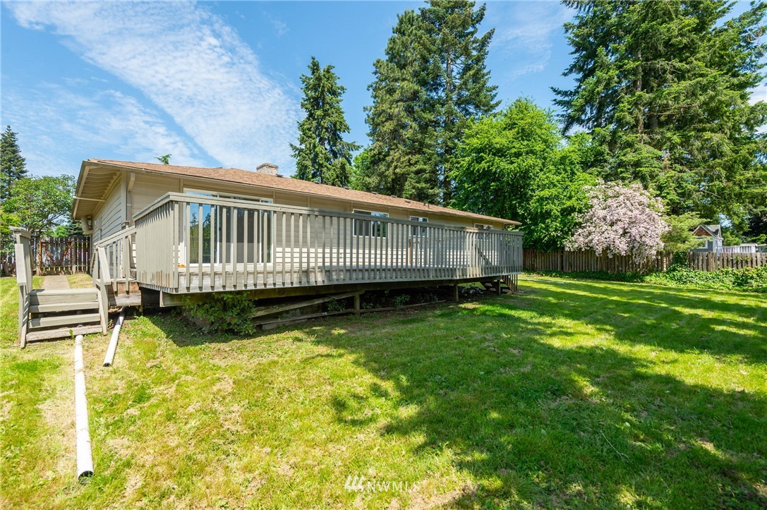 4131 Northeast 19th Street Renton, WA 98059 - Photo 35 of 40 a view of a house with a wooden deck and a yard