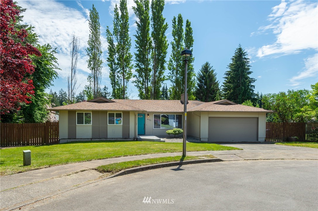 4131 Northeast 19th Street Renton, WA 98059 - Photo 39 of 40 a front view of a house with a garden and trees