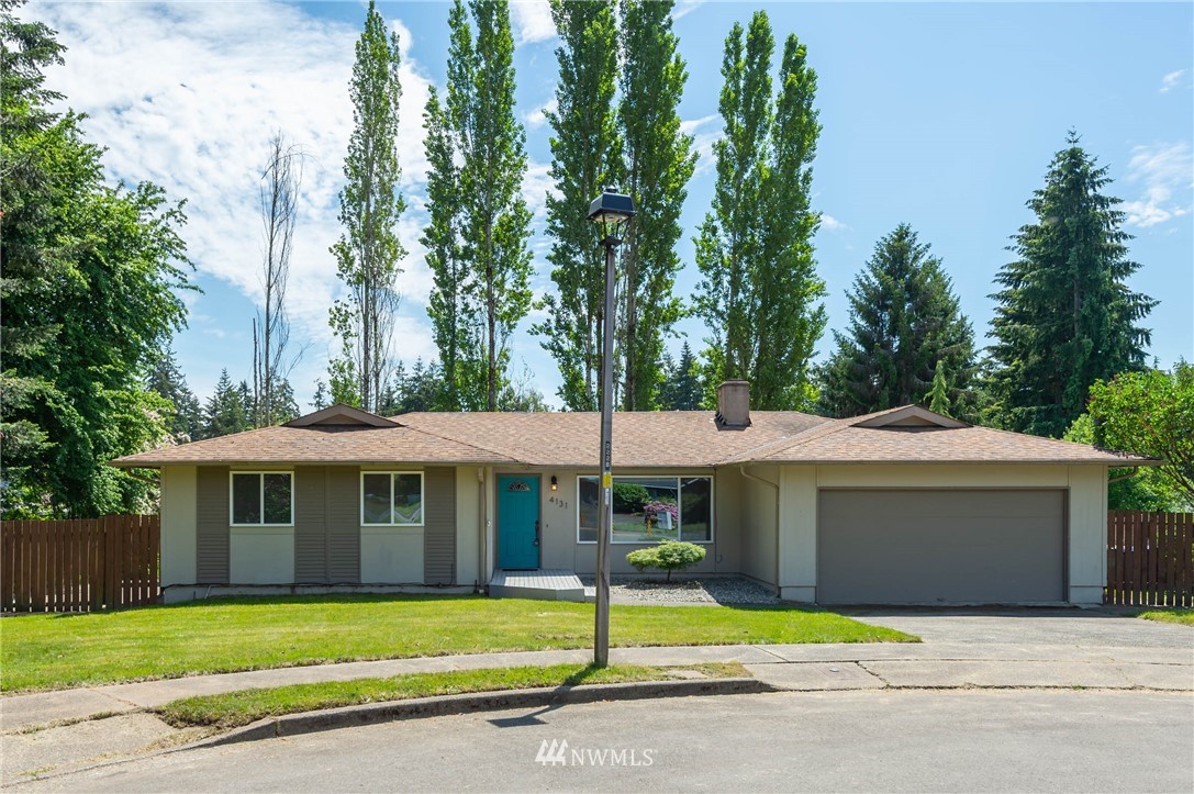 4131 Northeast 19th Street Renton, WA 98059 - Photo 40 of 40 a front view of a house with a garden
