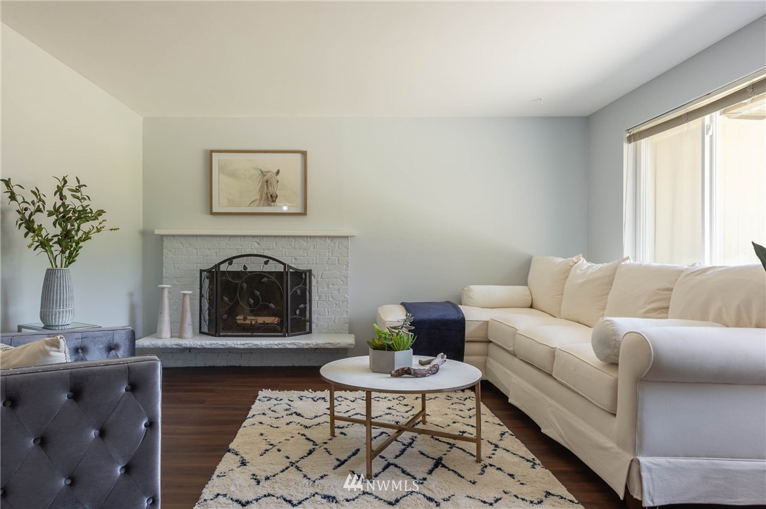 4131 Northeast 19th Street Renton, WA 98059 - Photo 5 of 40 a living room with furniture and a fireplace