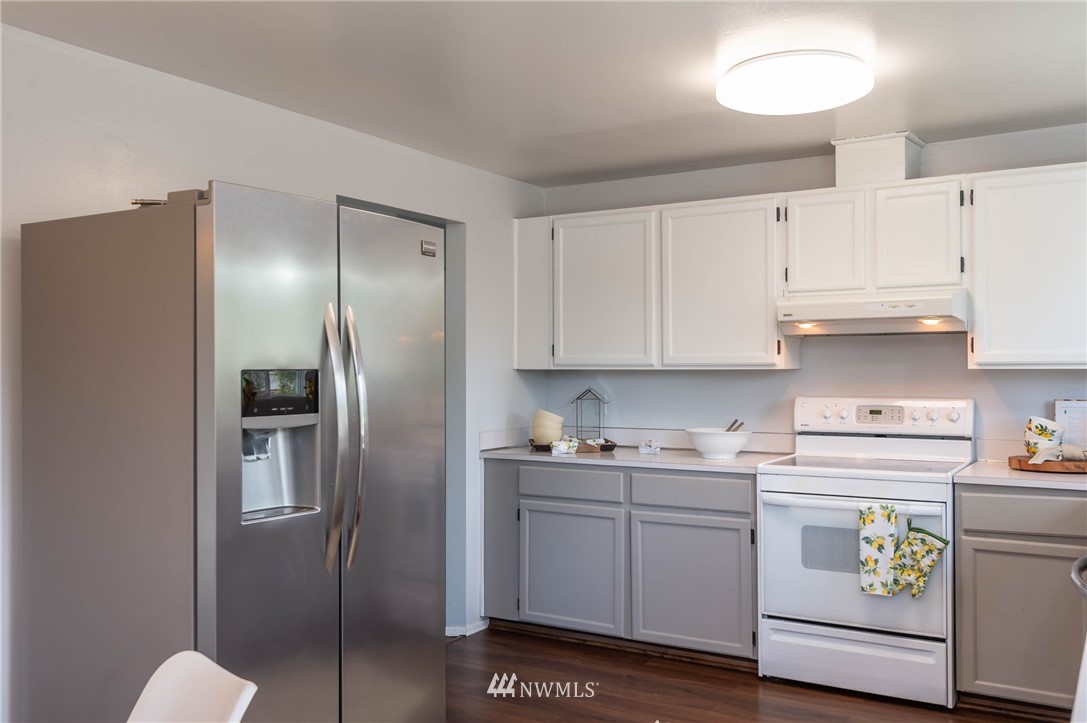 4131 Northeast 19th Street Renton, WA 98059 - Photo 6 of 40 a kitchen with a refrigerator sink and cabinets