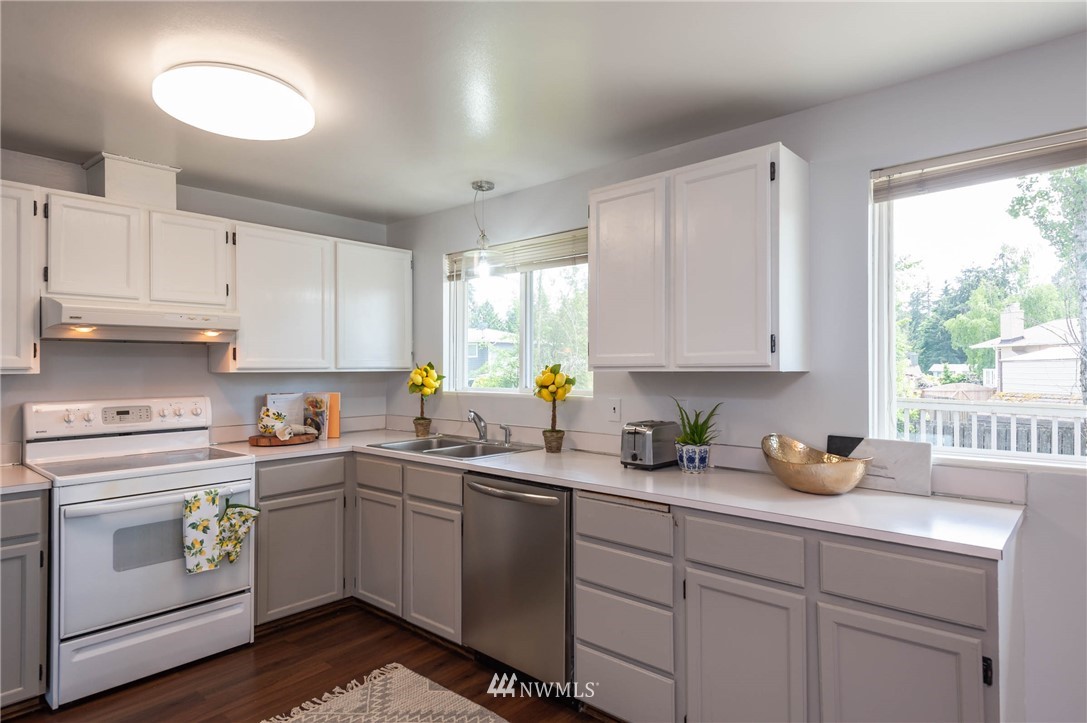 4131 Northeast 19th Street Renton, WA 98059 - Photo 7 of 40 a kitchen with a sink stove and cabinets