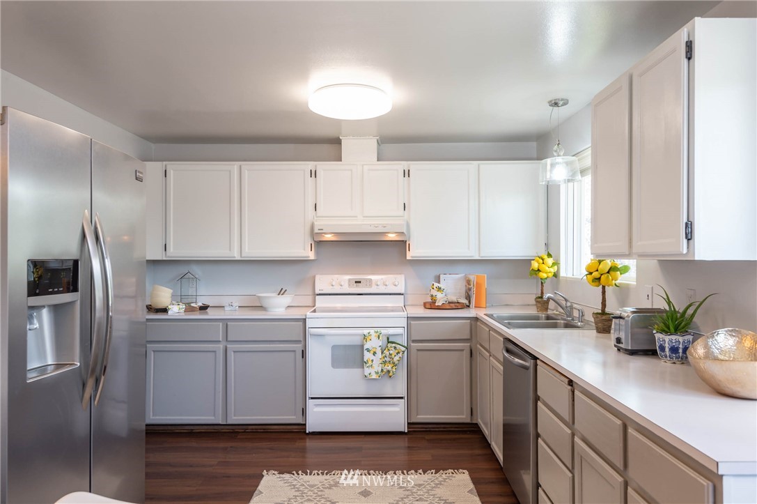 4131 Northeast 19th Street Renton, WA 98059 - Photo 8 of 40 a kitchen with a sink white cabinets and stainless steel appliances