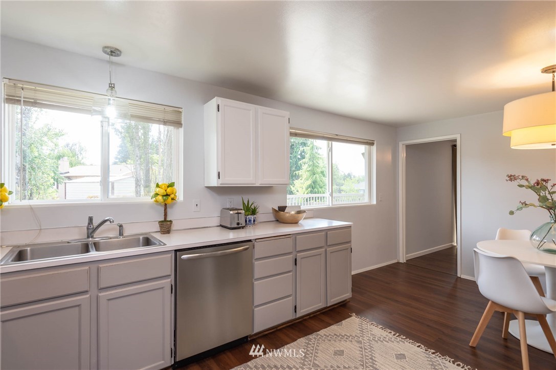 4131 Northeast 19th Street Renton, WA 98059 - Photo 10 of 40 a kitchen with a sink window and cabinets