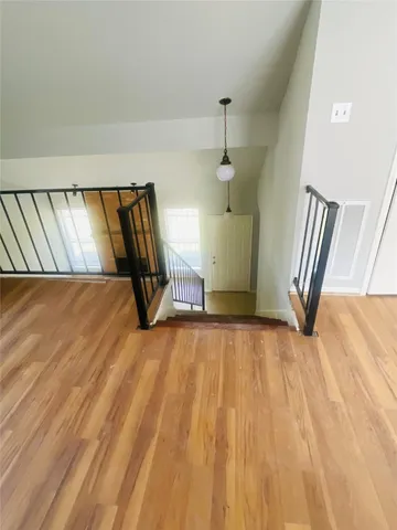 a view of a room with wooden floor and stairs