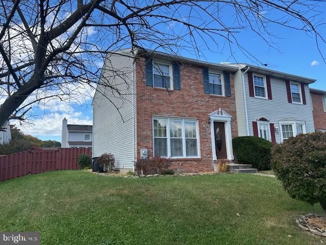 a brick house with a large window and a yard