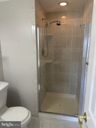 a white toilet sitting next to a bathroom sink
