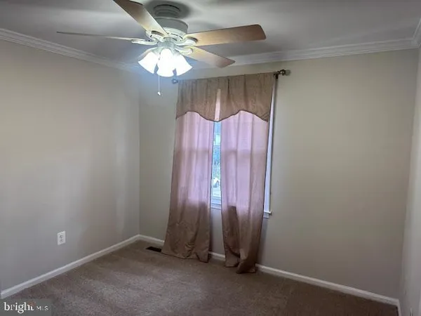 a view of a room with window and ceiling fan