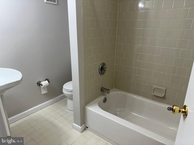 9022 Deviation Road Baltimore, MD 21236 - Photo 20 of 27 a white bath tub sitting next to a white toilet