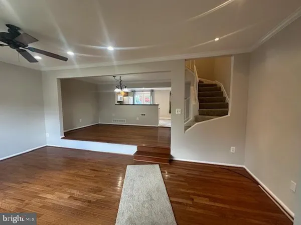 a view of a ceiling fan and wooden floor