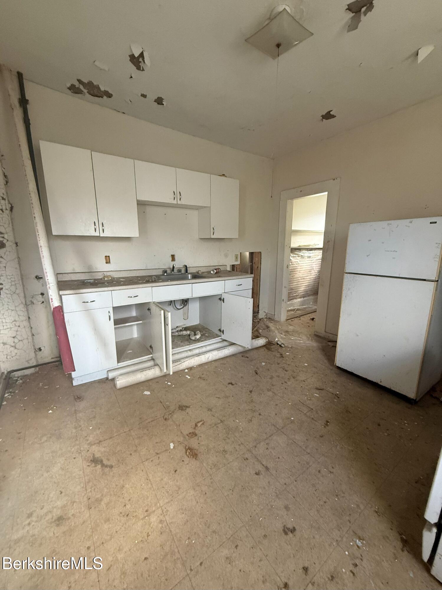 32-38 Spring Street North Adams, MA 01247 - Photo 15 of 32 a kitchen with a stove and a refrigerator