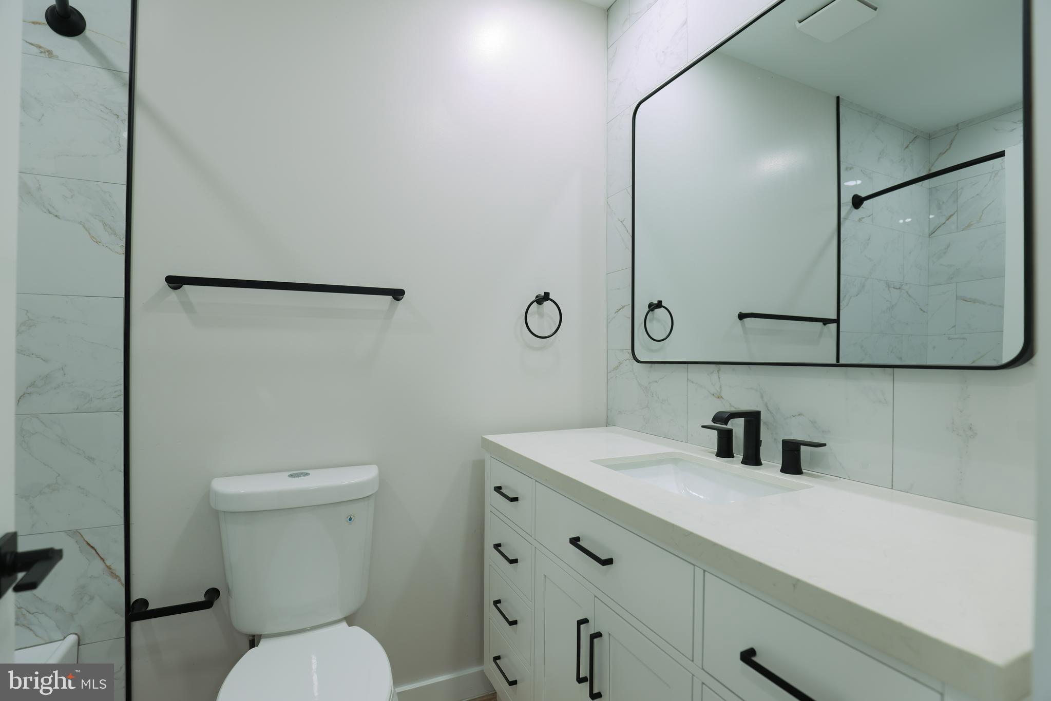 2039 Rosedale Street Northeast Washington, DC 20002 - Photo 11 of 18 a bathroom with a toilet sink and mirror