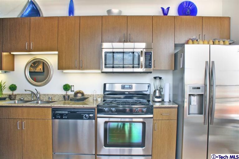 200 North San Fernando Road, Unit 314 Lincoln Heights, CA 90031 - Photo 8 of 28 a kitchen with kitchen island a stove a refrigerator and a sink