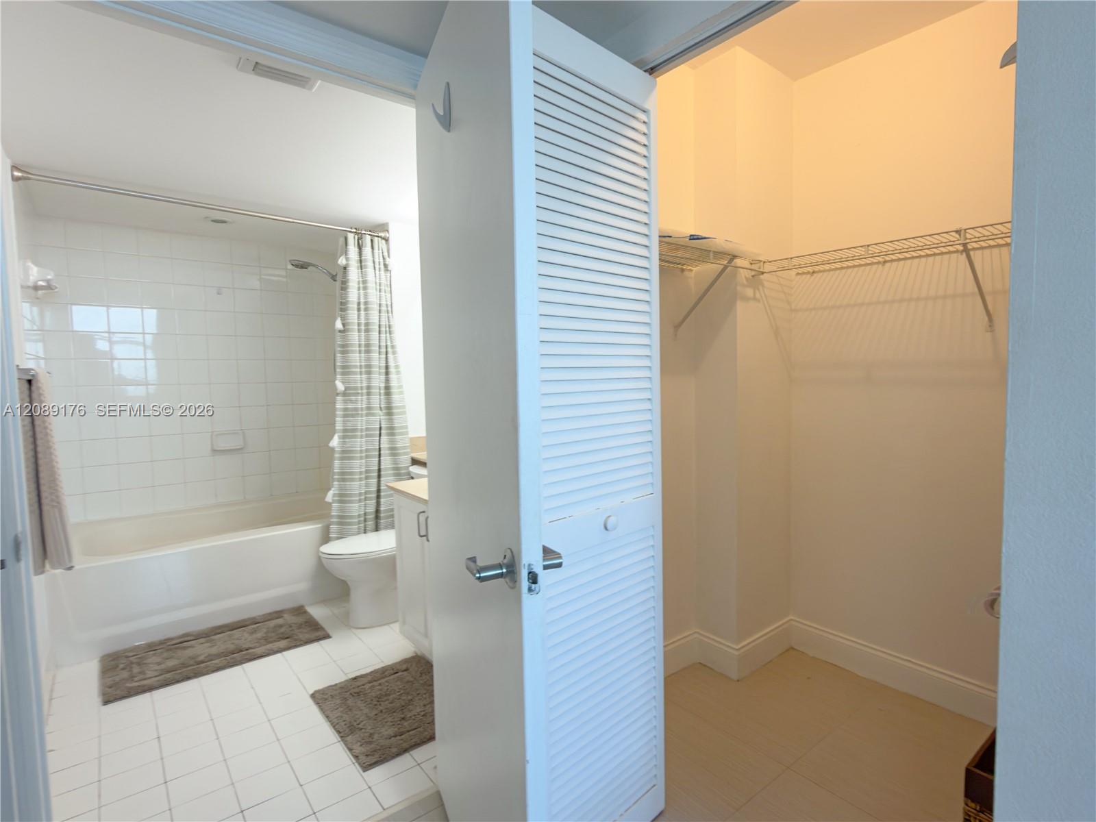 90 Alton Road, Unit 1710 Miami Beach, FL 33139 - Photo 13 of 16 Primary bathroom featuring a walk-in closet