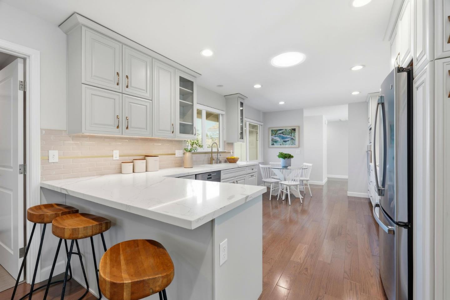 1380 Ridgeley Drive Campbell, CA 95008 - Photo 12 of 39 a kitchen with a table chairs and a refrigerator