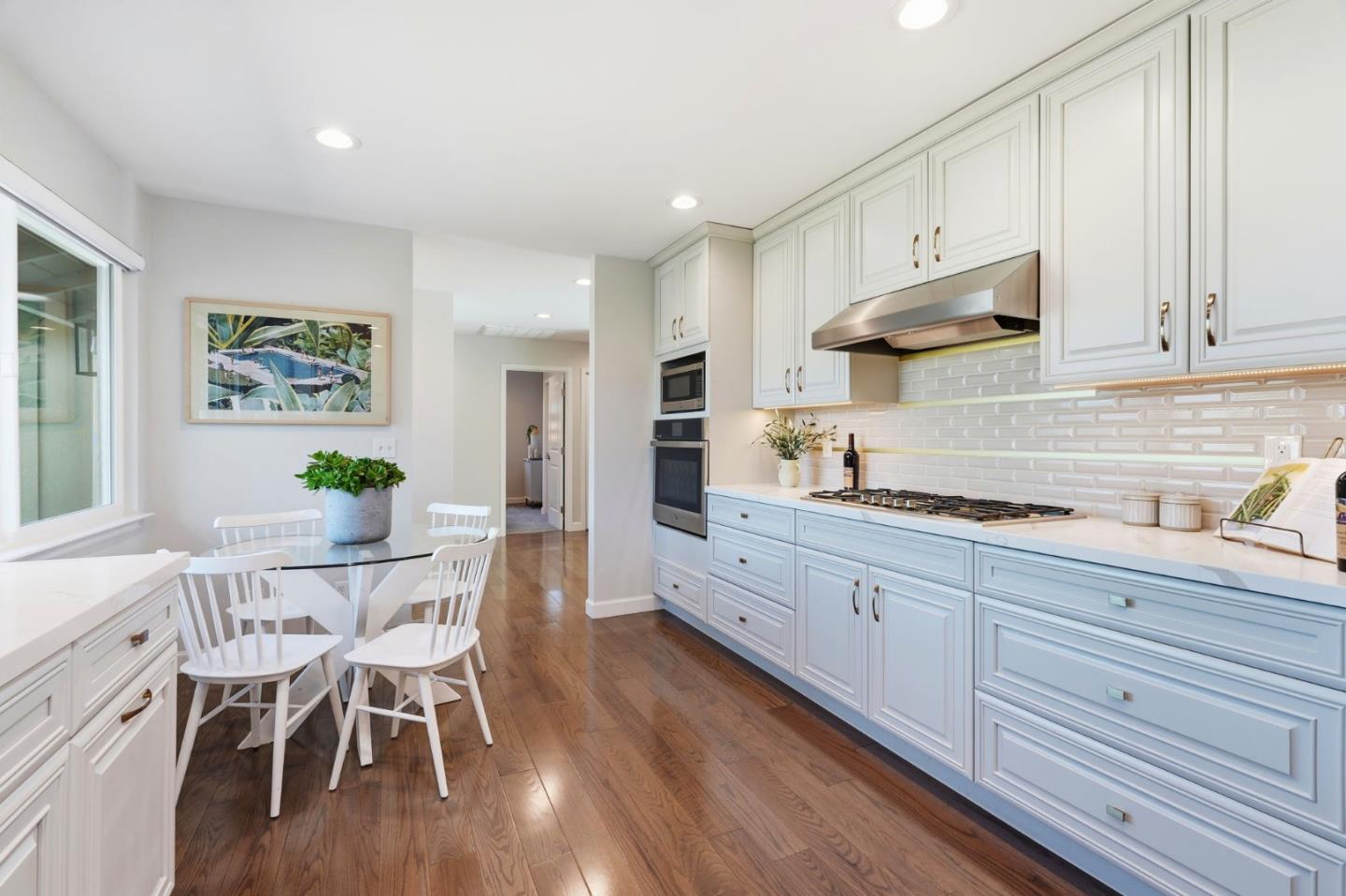 1380 Ridgeley Drive Campbell, CA 95008 - Photo 13 of 39 a kitchen with granite countertop white cabinets and stainless steel appliances
