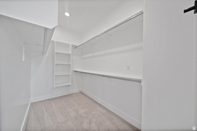 1117 East Shilow Road, Unit 106 Erda, UT 84074 - Photo 11 of 21 Spacious walk-in closet featuring light-toned carpet flooring, white walls, and built-in shelving units