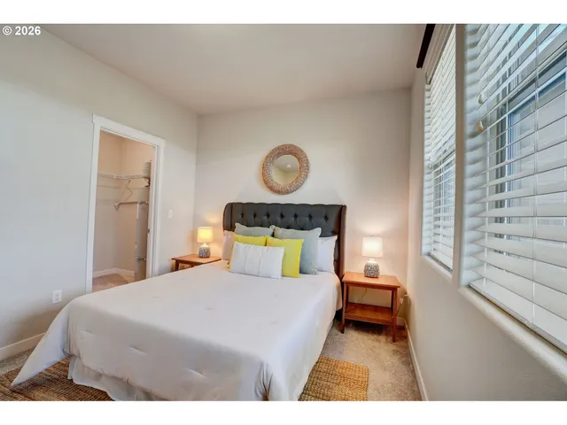 a bedroom with a bed and a window