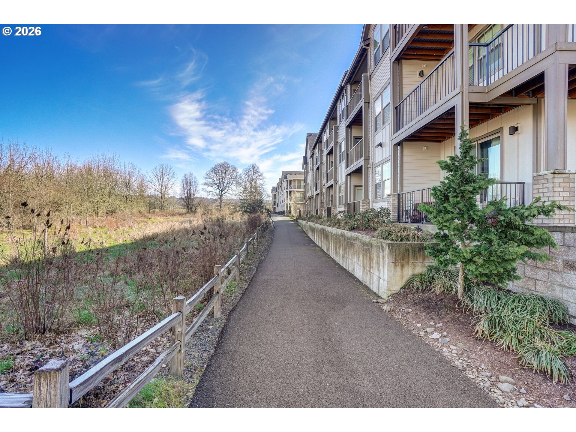 16417 Northwest Chadwick Way, Unit 302 Portland, OR 97229 - Photo 14 of 20 a view of a lake with a building in the background