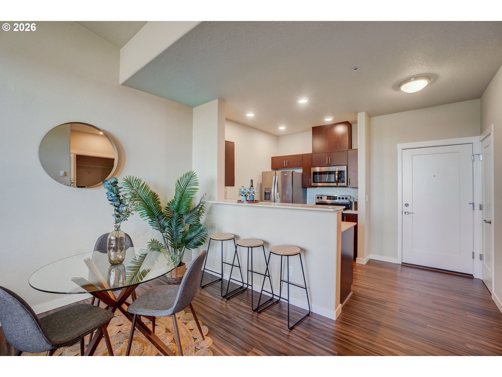 16417 Northwest Chadwick Way, Unit 302 Portland, OR 97229 - Photo 5 of 20 a view of a dining room with furniture and wooden floor