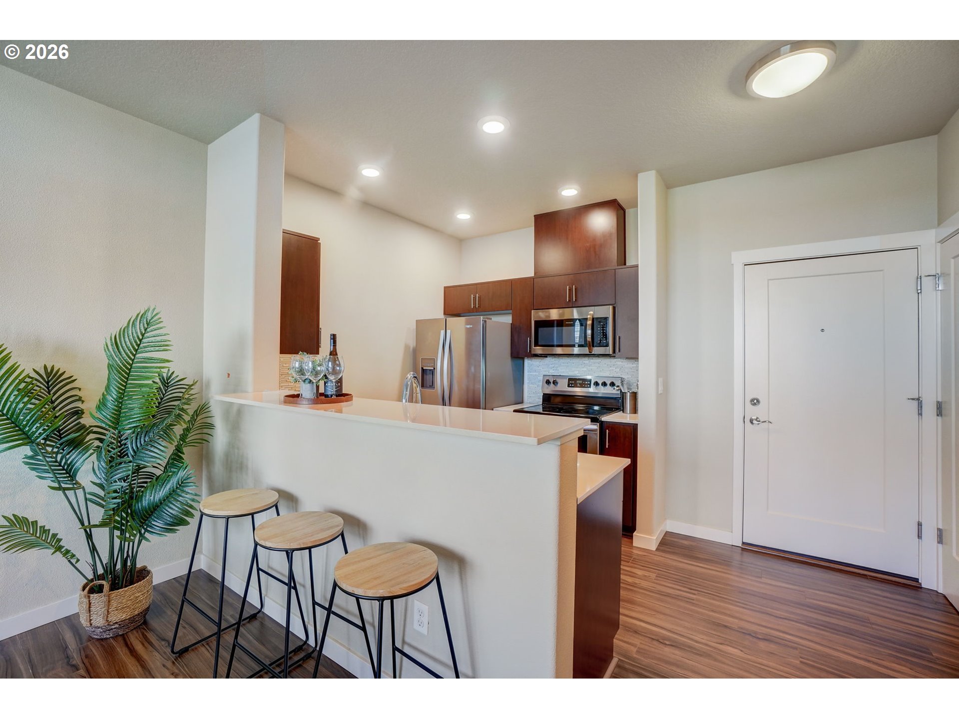16417 Northwest Chadwick Way, Unit 302 Portland, OR 97229 - Photo 6 of 20 a kitchen with stainless steel appliances kitchen island granite countertop a refrigerator and a stove