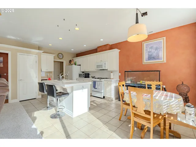 a kitchen with a dining table chairs and view kitchen