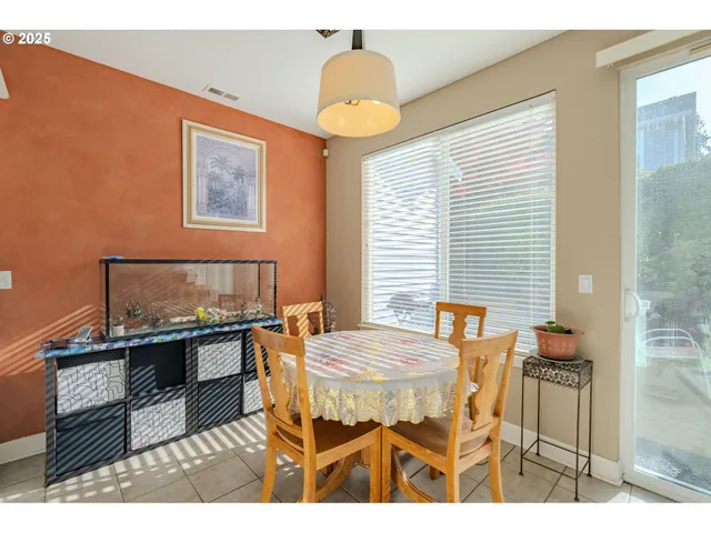 a view of a dining room with furniture and chandelier