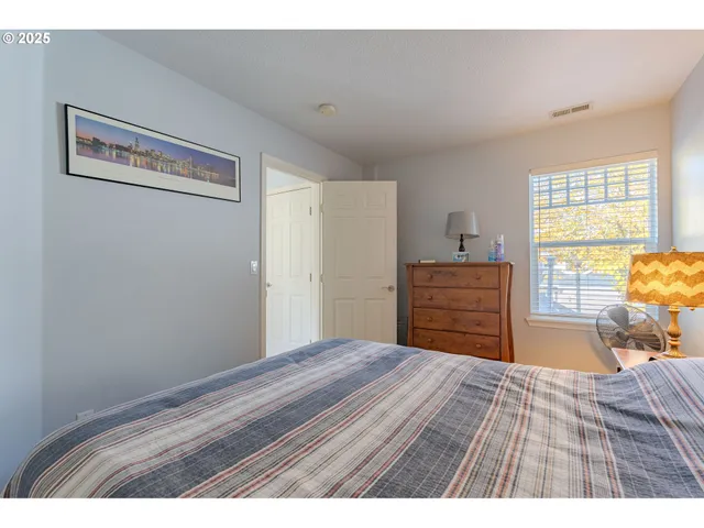 a bedroom with a bed and dresser