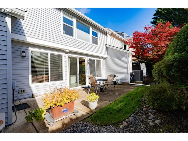 a view of a house with backyard sitting area and garden