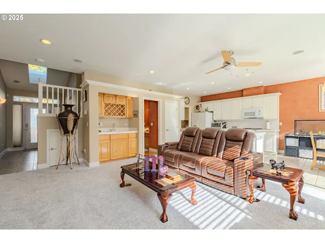 a living room with furniture a flat screen tv and a table