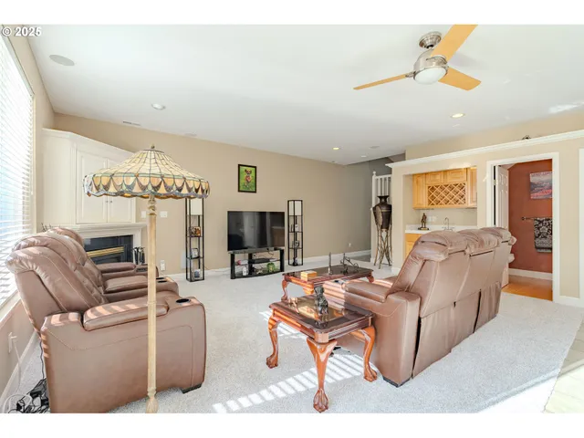 a living room with furniture a flat screen tv and a window