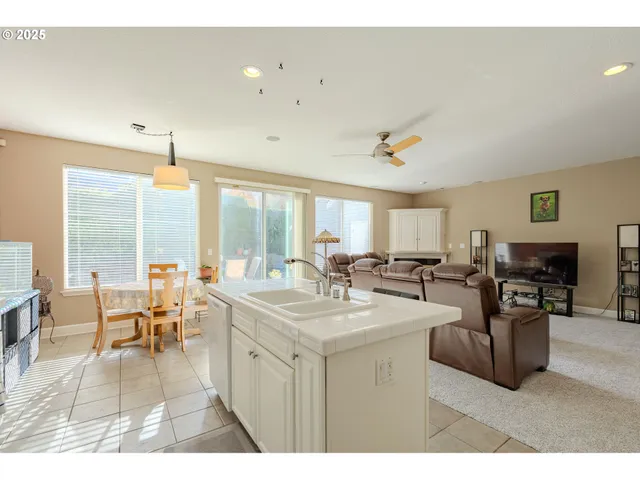 a living room with furniture a dining table and a large window