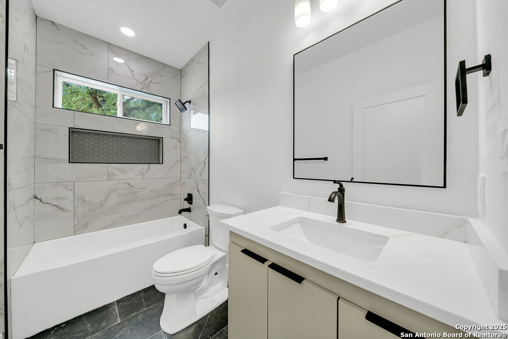 661 Jonquil Drive Spring Branch, TX 78070 - Photo 16 of 18 a bathroom with a sink a toilet and a bathtub